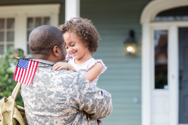 Child with Army father at home